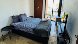 A bedroom with a bed, a desk, a chair, and a wardrobe. - Supreme Cancun Hotel Zone #72 right in the heart of the Cancun Hotel Zone. (Cancún)