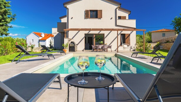 A modern house with a swimming pool, outdoor seating, and a patio area. - Casa del Mare... Quiet location... spacious swimming pool... relaxing vacation. (Lakmartin)