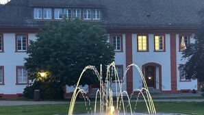 A building with a fountain in front.
