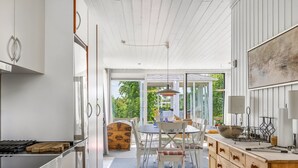 A modern kitchen with a dining area, large windows, and a view of greenery outside. - "Marret" - 275m from the sea by Interhome (Hejls)