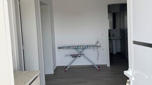 A hallway with a wooden floor, a ceiling light, and a door on the right. - Charming 3-bedroom Villa in lovely Shkodër with AC (Shkodër)