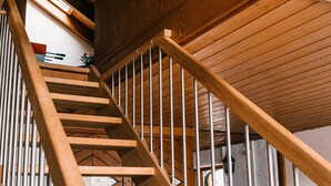 A wooden staircase with metal railings, leading to an upper level. - Holiday Apartment 'Alte Schneiderei' with Balcony and Wi-Fi (Heideck)