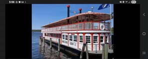 A paddle steamer docked at a pier.