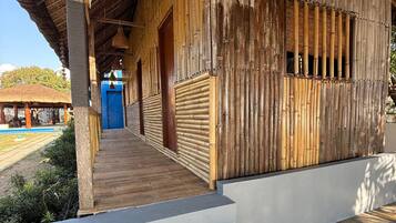 A wooden building with a covered porch and a blue door.