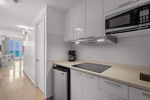 Fridge, microwave, coffee/tea maker, cookware/dishes/utensils