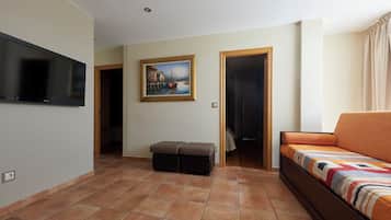 A modern living room with a flat-screen TV, a painting, a sofa, and a bench.