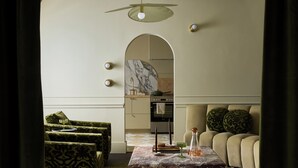 A living room with a marble coffee table, green patterned sofas, and a beige sofa with patterned cushions. - Designed for two couples, friends or a family, flat four is one of the edgiest suites in Hotel Julie (Stratford)