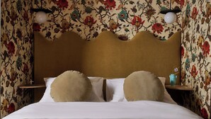 A bed with white linens, two beige pillows, and a wooden headboard. - Designed for the solo traveller or couple looking for a taste of the Hotel Julie experience. (Stratford)