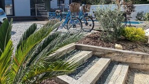 A residential area with a white building, bicycles, and a swimming pool. - 125m² Villa with Heated Pool, 3 Bedrooms, Terrace in La Flotte (La Flotte)