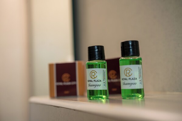 Two bottles of Royal Plaza Shampoo on a shelf.