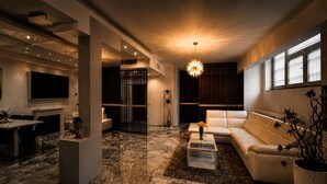 A modern living room with a sofa, coffee table, and a TV.