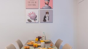 A dining table with breakfast items, a bottle, and juice glasses. - Residence City Retreat (Rodos)