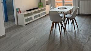 A modern kitchen with a dining area, a world map on the wall, and a view of the outdoors. - Daniel Apartment (Unknown)