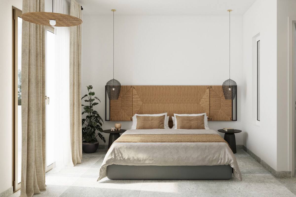 Un dormitorio moderno con una cama grande, cabecera de madera, una planta en maceta y una mesita redonda.