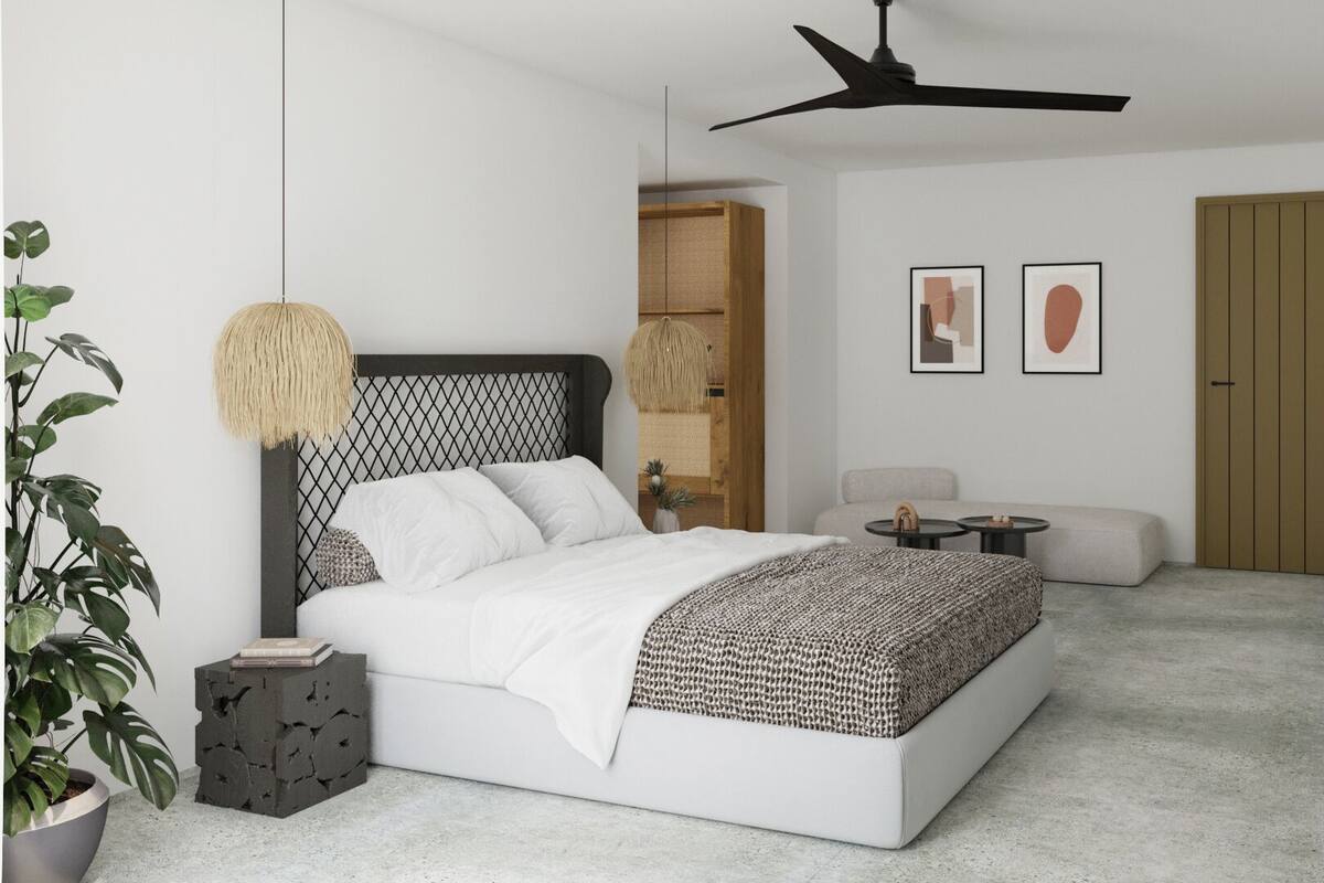 Un dormitorio moderno con cama, mesitas de noche, ventilador de techo, sofá, una pequeña mesa y televisor.