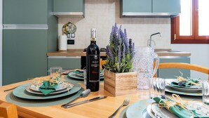 A dining table set with plates, cutlery, a bottle of wine, and a decorative plant. - Lovely apartment for 4 people with A/C, WIFI, terrace, pets allowed and panoramic view (Andora)