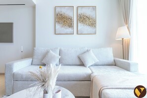 Luxury Apartment, Balcony, City View | Living area | 65-inch Smart TV with cable channels