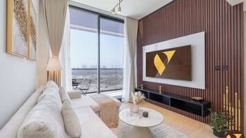 Luxury Apartment, Balcony, City View | Living area | 65-inch Smart TV with cable channels