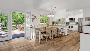 A spacious kitchen with a dining area, large windows, and a view of the outdoors. - The Greatest Cove, Man! | Spectacular Panoramic Playground (Henrico)