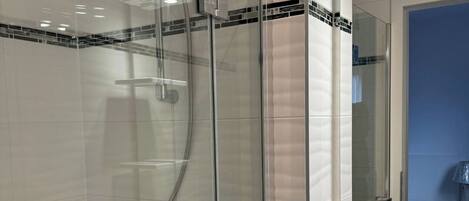 Shower, hair dryer, towels, toilet paper