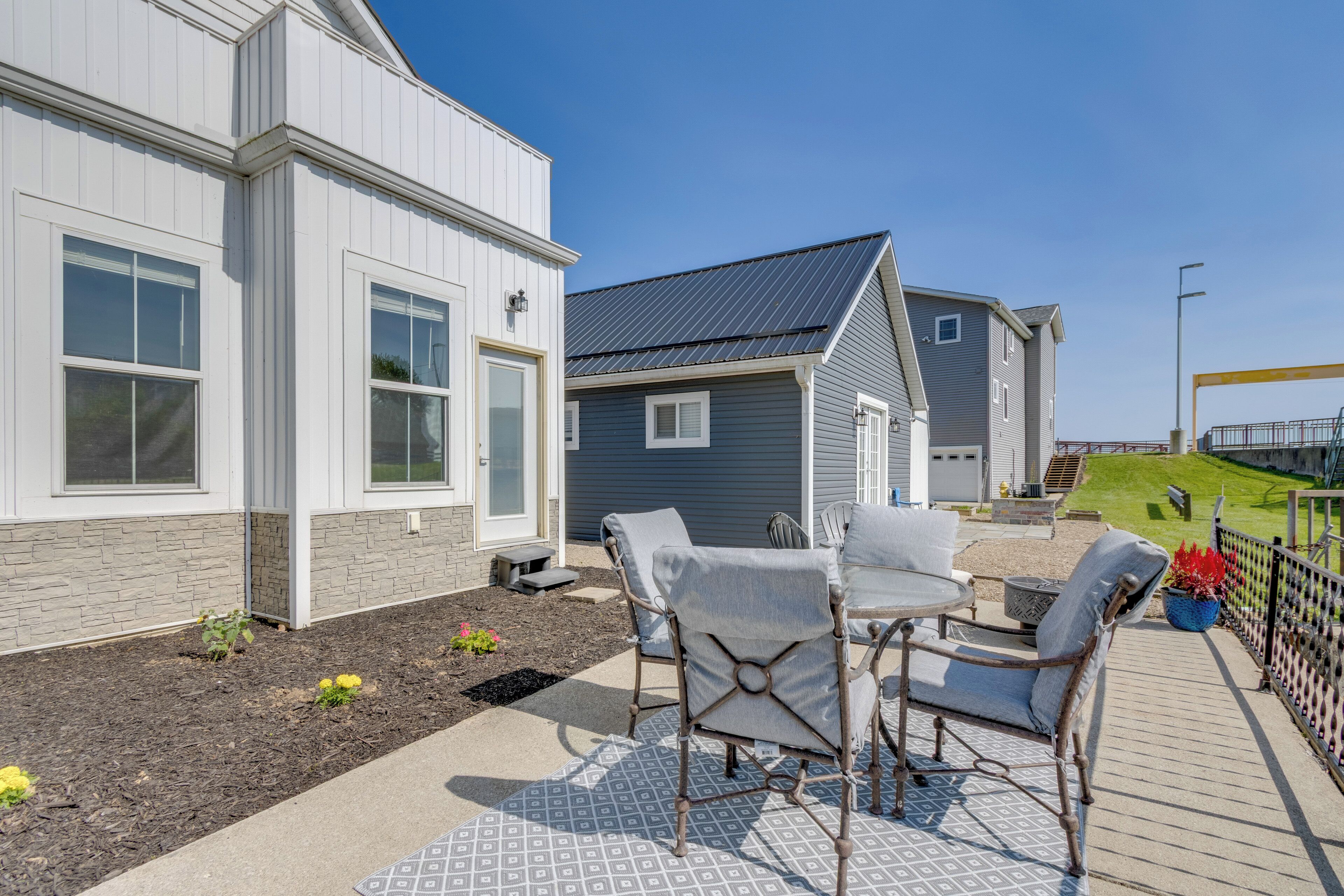 A modern house with a patio area featuring outdoor furniture and a well-maintained garden.