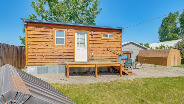 A small wooden cabin with a front door, windows, and a small porch area. - Hike, Fish & More: Cozy Studio w/ Yard in Augusta! (Augusta)