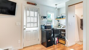 A compact kitchen with a refrigerator, microwave, and a small window. - Hike, Fish & More: Cozy Studio w/ Yard in Augusta! (Augusta)