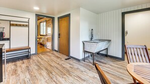 A modern interior with a wooden floor, a bench, a sink, and a chair. - 1 Mi to Town: Woodland Park Home w/ Yard! (Woodland Park)
