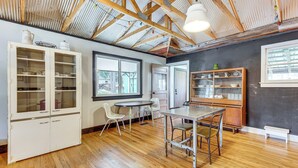 A room with wooden beams, a dining table, chairs, and cabinets with glass doors. - 1 Mi to Town: Woodland Park Home w/ Yard! (Woodland Park)