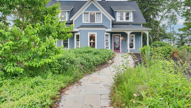 A two-story house with a stone pathway leading to the front door. - 2 Mi to Chardon Square: Family Farmhouse Escape (Chardon)