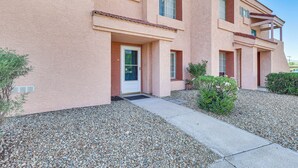 A multi-story building with a stucco exterior, a front door, and a small porch area. - 1 Mi to Beach: Lake Havasu City Condo w/ Balcony (Lake Havasu City)