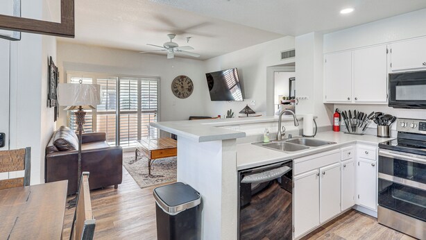 A modern kitchen with white cabinetry, a built-in oven, and a microwave. - 1 Mi to Beach: Lake Havasu City Condo w/ Balcony (Lake Havasu City)