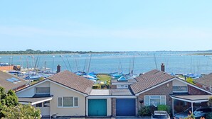 Une zone résidentielle côtière comprenant des maisons, un port de plaisance et des bateaux.