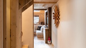 A wooden interior with a staircase leading to a living area. - Casa Verocip, a panoramic attic with a view of the Dolomites (Cortina d´Ampezzo)