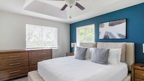 A bedroom with a bed, two bedside tables, a ceiling fan, and a dresser. - Landing | Stunning 3BD, Pool (Homestead)
