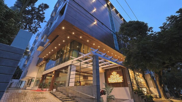 A modern hotel with a prominent entrance, large windows, and a well-lit facade.