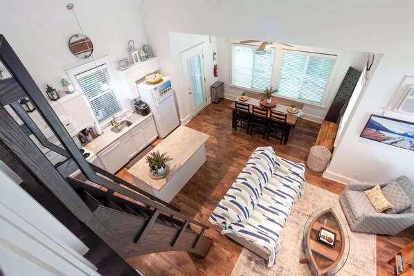 A modern apartment with a kitchen, dining area, and living room. - The Spring Peeper - 28 Hollow (Prince Edward)