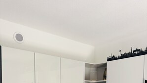 A modern kitchen with white cabinets, black countertops, and a variety of kitchen appliances. - Beautiful, sun-drenched vacation apartment on the Dünsberg - surrounded by greenery (Biebertal)