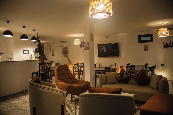 A modern living room with a sofa, armchairs, and a dining area. - Dar Lina  (El Haouaria)
