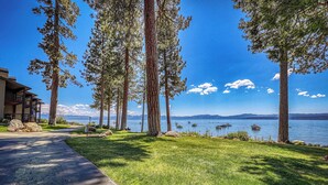 A pathway leading to a building with a view of a lake and mountains. - Million Dollar Views of Lake Tahoe - #13 (Kings Beach)