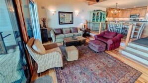 A cozy living room with a sofa, armchairs, and a patterned rug. - Serene Lakefront Townhouse with Breathtaking Views at Brockway Springs- #4 (Kings Beach)