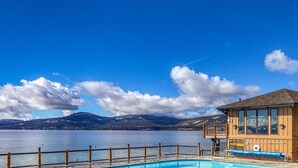 A wooden building with a pool, overlooking a lake with mountains in the background. - Newly Remodeled Lake-View retreat #21 (Kings Beach)