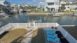 A residential area with a swimming pool, a dock, and houses with balconies.