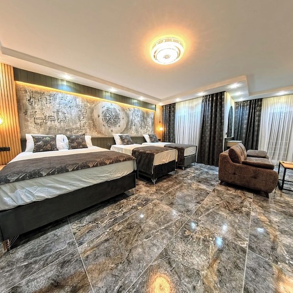 A hotel room with two beds, a sofa, and a large wall mural. - Tikir House (Denizli)