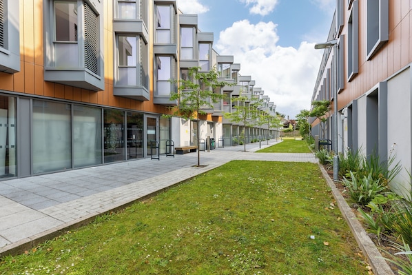 A modern apartment building with a long, straight driveway and a well-maintained lawn. - For Students Only Curraheen Point  (Cork)
