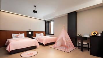 A modern hotel room with two beds, a desk, a chair, a laptop, and a small tent-like structure.