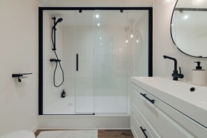 Shower, hair dryer, towels, toilet paper