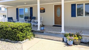 A building with a porch, numbered 351, featuring outdoor seating and potted plants. - Summer Breezes, Bay Views (Lower Township)
