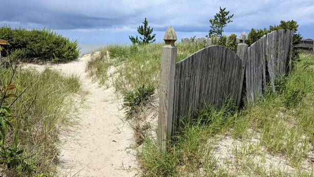 A sandy path leading to a wooden fence with a decorative post. - Summer Breezes, Bay Views (Lower Township)