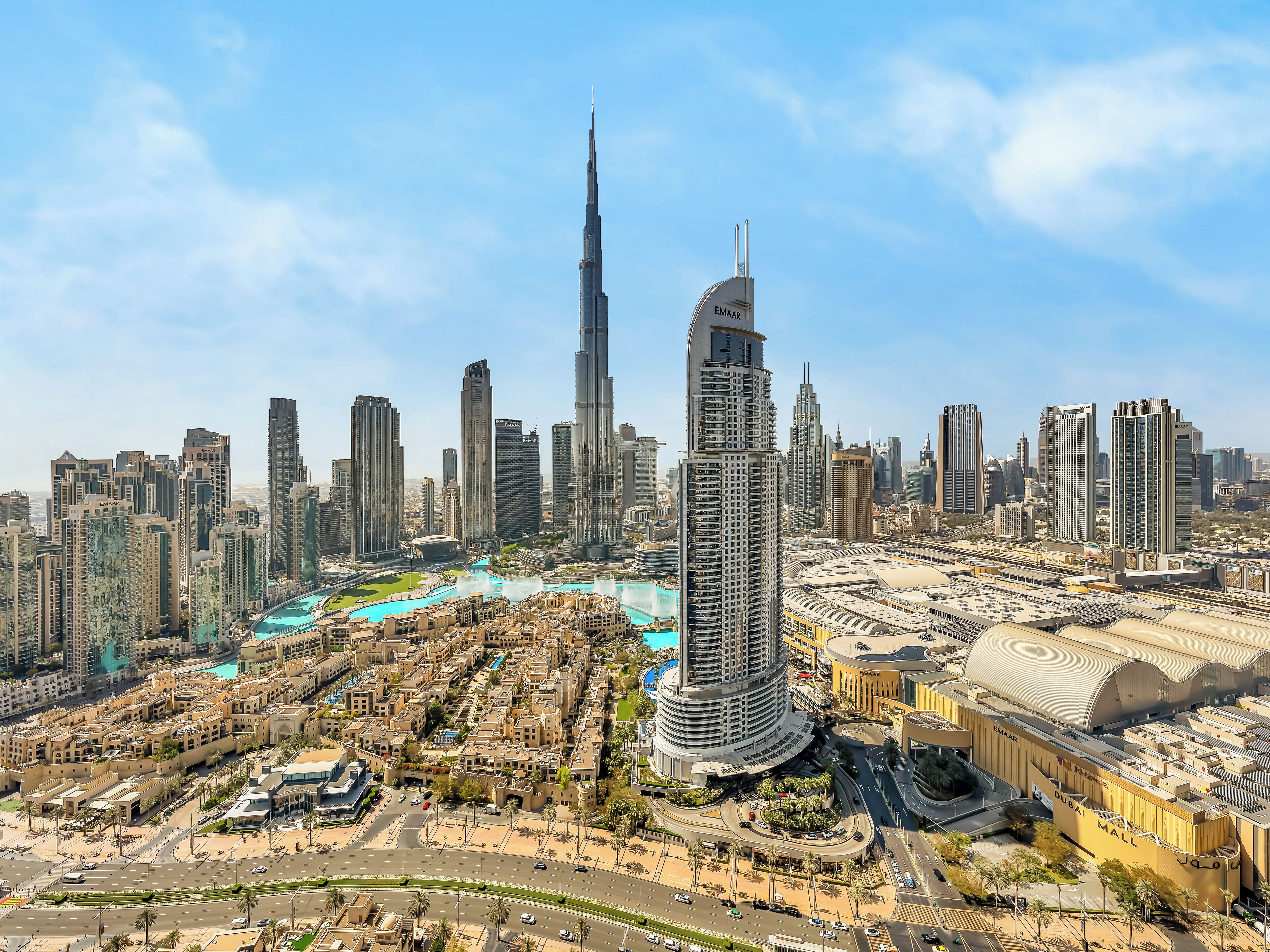 A cityscape with a prominent tower, a large shopping mall, and a well-planned urban layout.